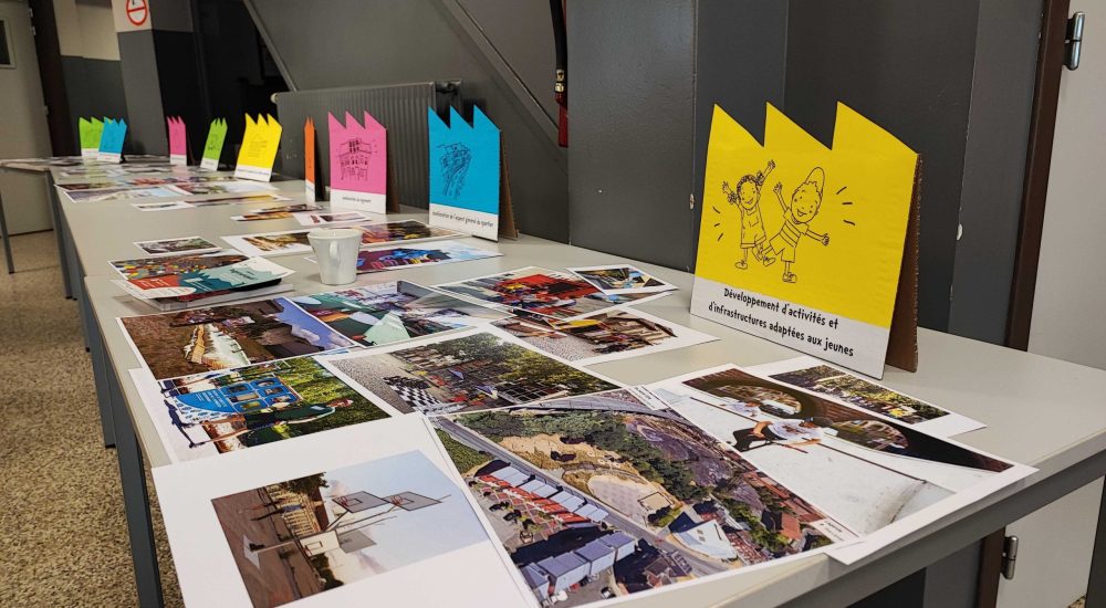 Plusieurs photos déposées sur une table pendant une exposition.